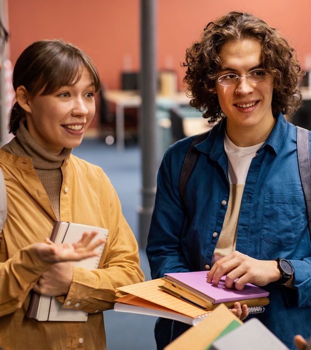 university-colleagues-talking-library.jpg